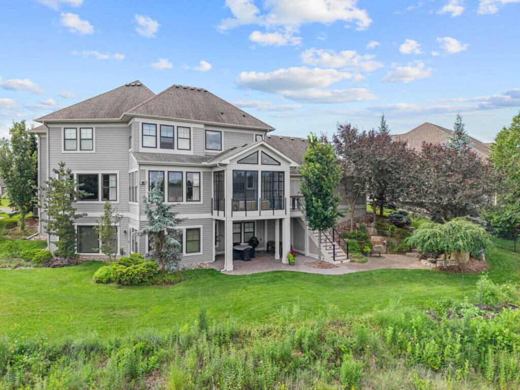 Completed three-season porch addition overlooking a landscaped backyard.