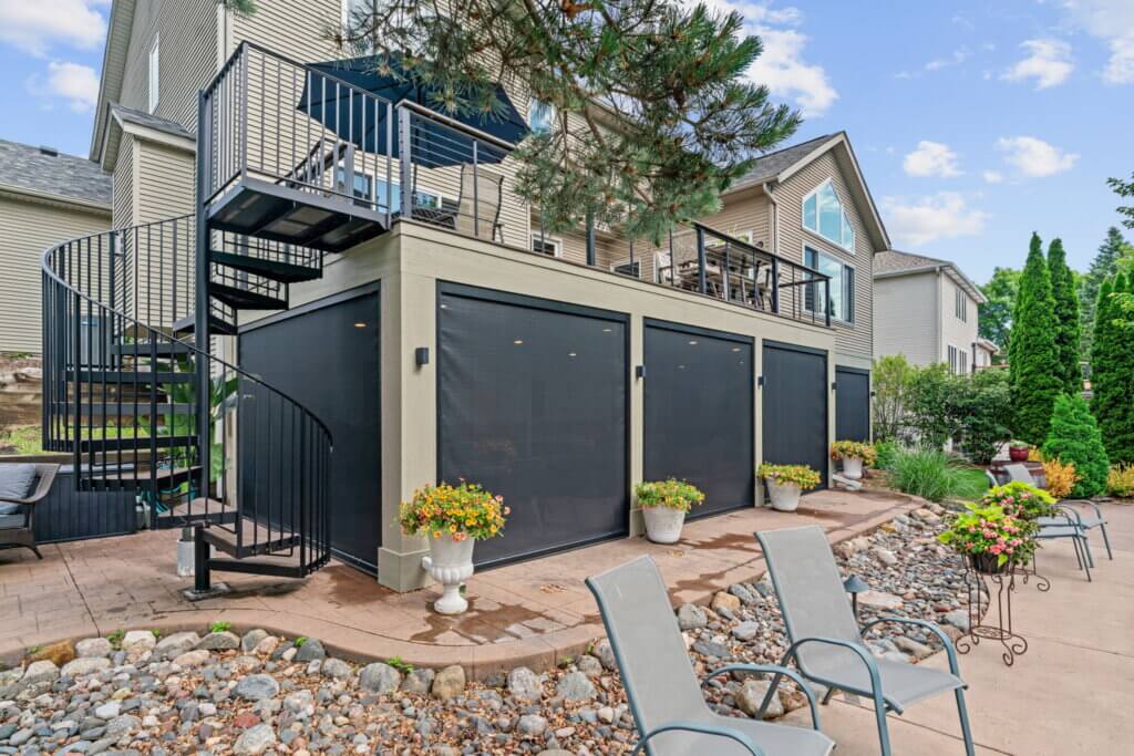 Completed elevated deck with spiral staircase and screened storage areas beneath.