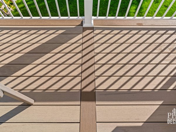 Close-up of The Oakview Deck showing Weathered Oak decking with contrasting Dark Oak picture framing and white railing.