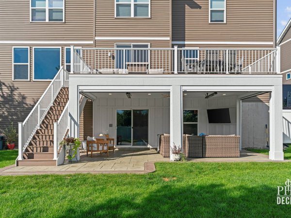 The Oakview Deck with white railing and a covered patio with retractable screens fully open.