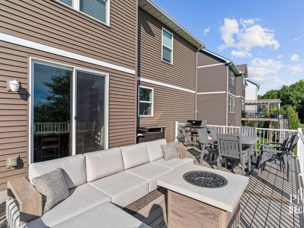 The Oakview Deck with Weathered Oak decking, white railing, outdoor dining, lounge seating, and grill.