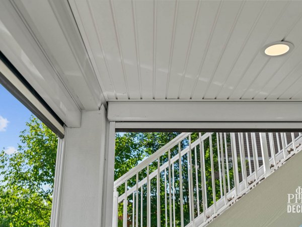 White underdeck ceiling with recessed lighting and retractable screen housing on The Oakview Deck.