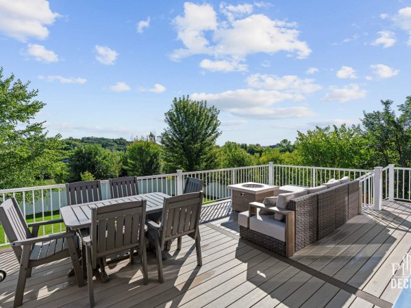 The Oakview Deck with Weathered Oak decking, white railing, outdoor dining, lounge seating, and grill.