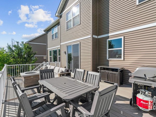 The Oakview Deck with Weathered Oak decking, white railing, outdoor dining, lounge seating, and grill.