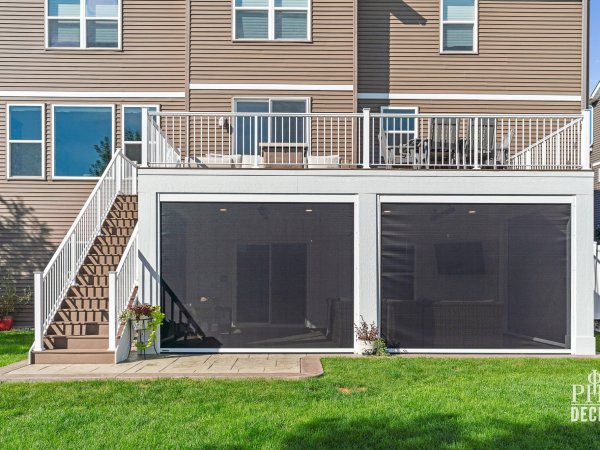 The Oakview Deck with white railing, Dark Oak stairs, and two closed retractable screens enclosing the patio below.