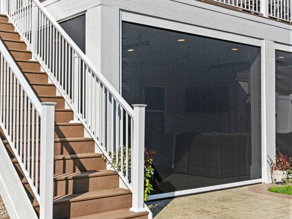 The Oakview Deck stairs with white railing and a Suncoast retractable screen enclosing the covered patio below.