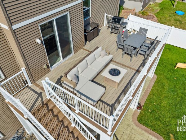 Overhead view of The Oakview Deck in Victoria, MN, with Weathered Oak decking, white railing, dining area, and lounge seating
