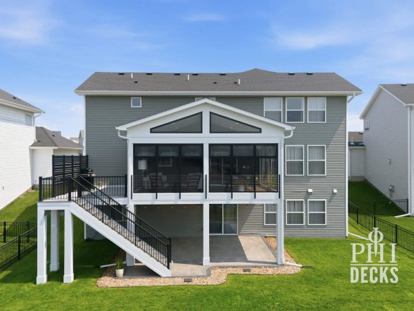 Exterior of the Pondview Porch with black windows, deck stairs, cable railing, and covered patio below.