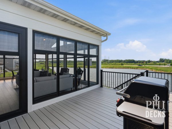 Pondview Porch deck with TimberTech decking, black railing, grilling area, and pond view in Rogers, Minnesota.