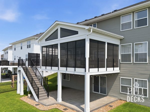 Exterior of the Pondview Porch with black Xtend windows, cable railing, deck stairs, and covered patio below.