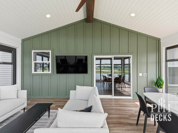 Interior of the Pondview Porch with Rosemary board-and-batten wall, vaulted ceiling, and outdoor living space